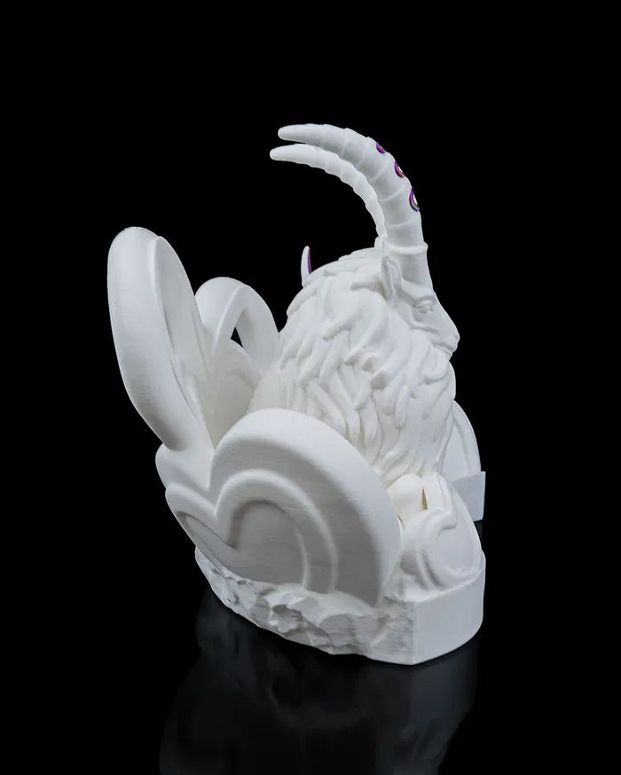 White sculpture of a Capricorn with large horns on a black background