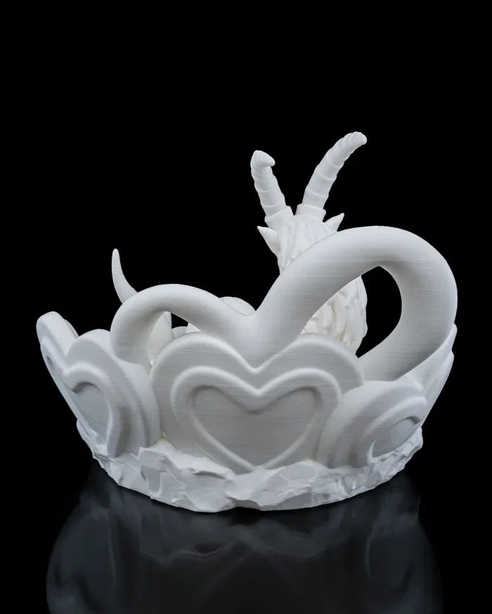 White ceramic Capricorn sculpture on a black background